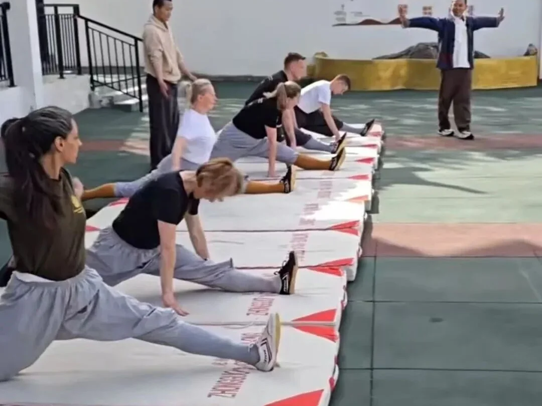 International students doing flexibility and stretching training indoors