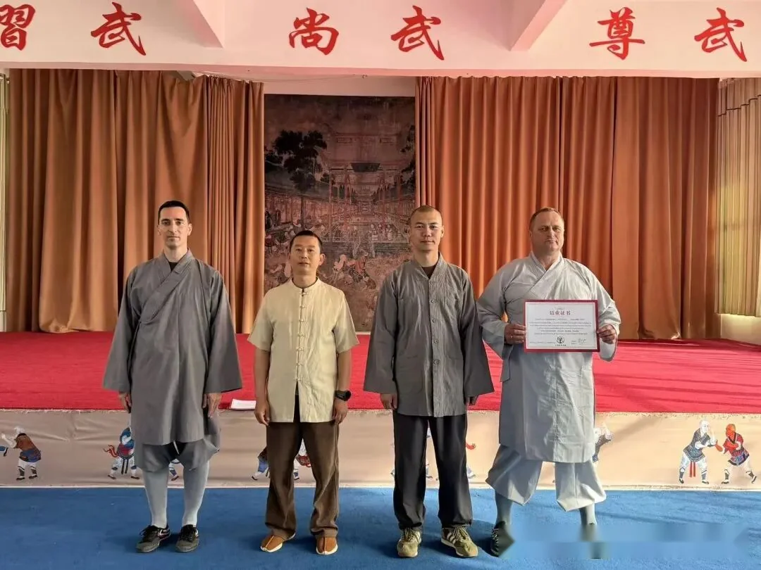 International student receiving the graduation certificate at Shaolin Zhongwu