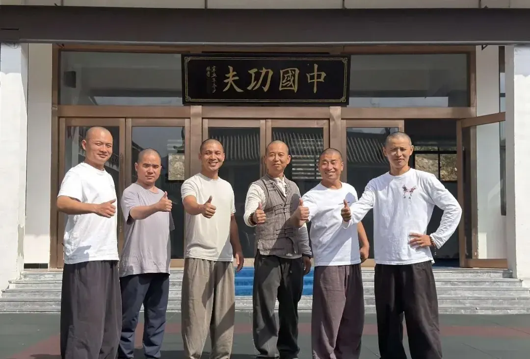 Masters from Macao and Shaolin Zhongwu giving thumbs up after the exchange