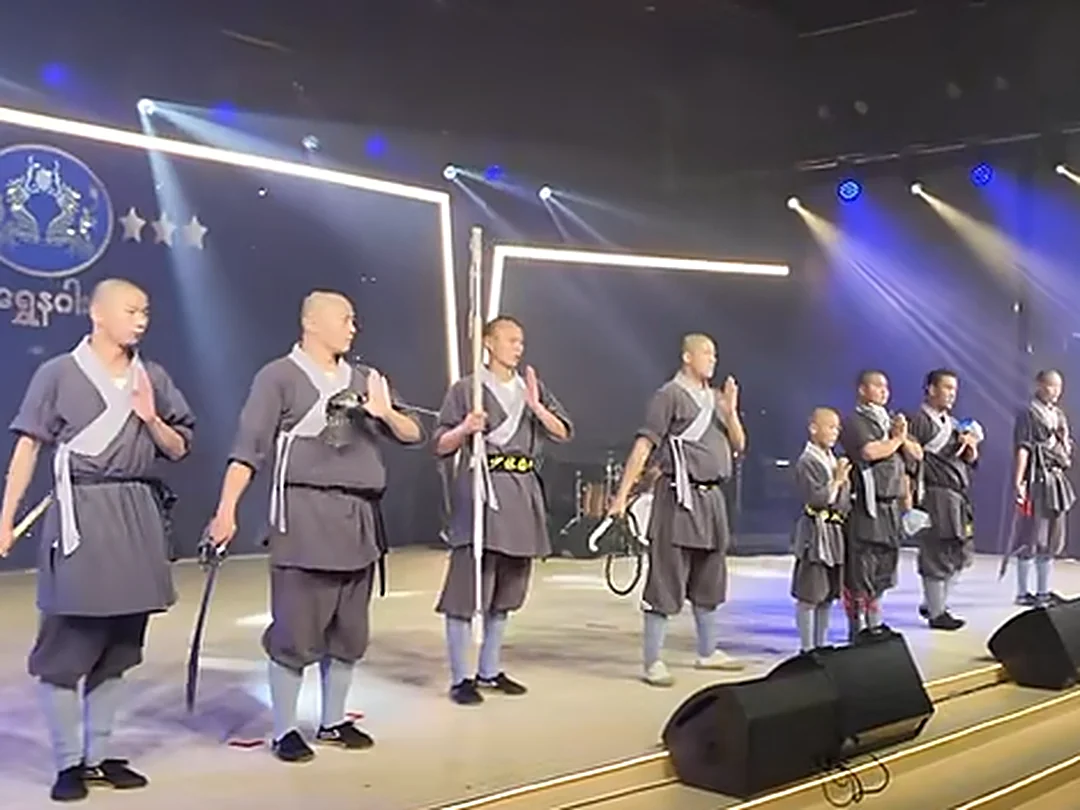Shaolin Zhongwu team bowing with weapons after the performance in Myanmar