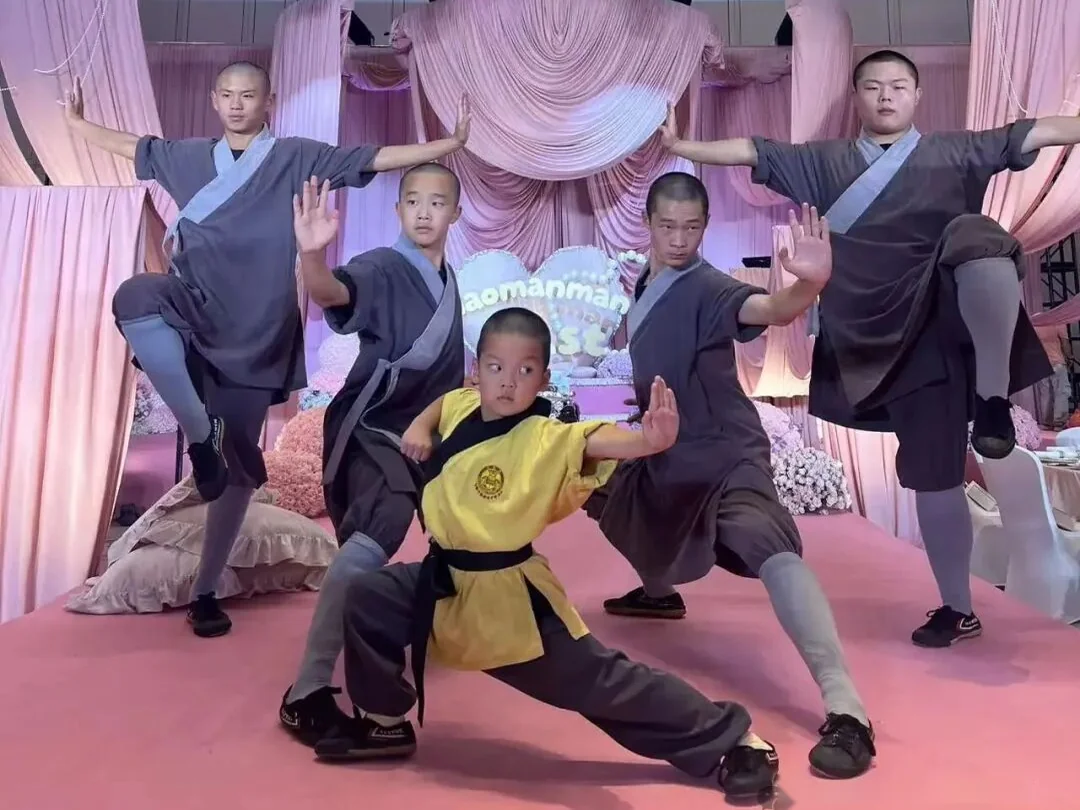 Young Shaolin students demonstrating kung fu poses on the stage in Shanghai