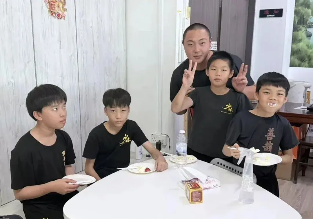 Shaolin Zhongwu coach and young students sharing a snack break in Singapore