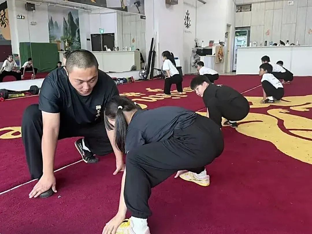 Shaolin Zhongwu coach guiding a young student through basic stances in Singapore