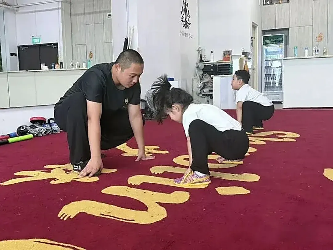 Shaolin Zhongwu coach demonstrating movements for students in Singapore